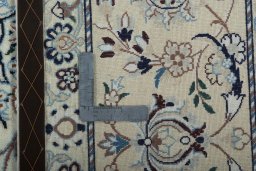 Backside of handmade New Nain rug showing knot structure and weave density
