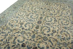 Backside of handmade 2000s Kashan rug showing knot structure and weave density