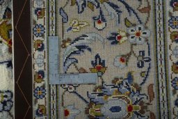 Backside of handmade 2000s Kashan rug showing knot structure and weave density