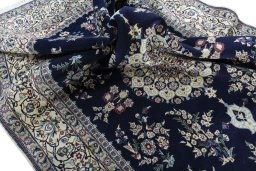 Surface texture of 2000s Nain rug with natural Wool and intricate pattern