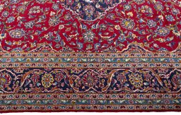 Corner detail of 2000s Kashan rug showing border pattern and Wool pile