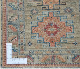 Corner detail of New Kazak rug showing border pattern and Wool pile