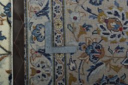 Backside of handmade 2000s Kashan rug showing knot structure and weave density