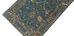 Backside of handmade New Farahan rug showing knot structure and weave density
