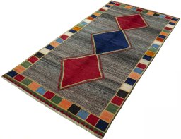 Corner detail of 1970s Persian Gabbeh rug showing border pattern and Wool pile