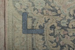Backside of handmade 1950s Vintage rug showing knot structure and weave density