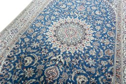 Backside of handmade 2000s Nain rug showing knot structure and weave density