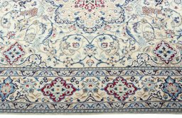Corner detail of 2000s Nain rug showing border pattern and Wool pile