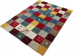 Corner detail of 2000s Persian Gabbeh rug showing border pattern and Wool pile