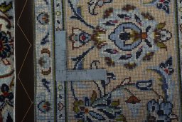 Backside of handmade 2000s Kashan rug showing knot structure and weave density