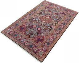 Corner detail of 2000s Kashan rug showing border pattern and Wool pile