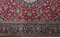 Corner detail of New Kashan rug showing border pattern and Cork pile