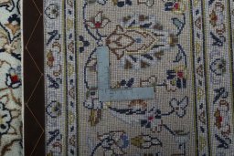 Backside of handmade 2000s Kashan rug showing knot structure and weave density