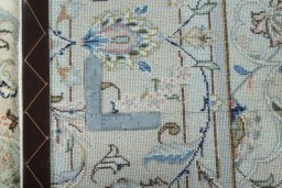 Backside of handmade New Kashan rug showing knot structure and weave density