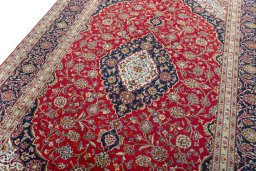 Backside of handmade 2000s Kashan rug showing knot structure and weave density