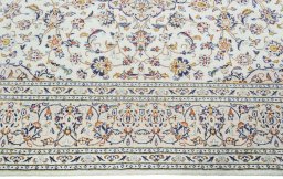 Corner detail of 2000s Kashan rug showing border pattern and Wool pile
