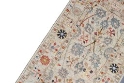 Backside of handmade New Farahan rug showing knot structure and weave density