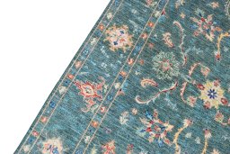Backside of handmade New Farahan rug showing knot structure and weave density