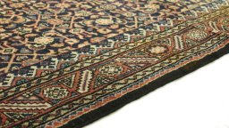 Backside of handmade 2000s Farahan rug showing knot structure and weave density