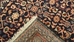 Close-up detail of 2000s Farahan rug from Iran / Persia showing Wool weave