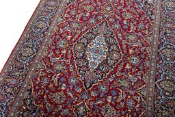 Backside of handmade 2000s Kashan rug showing knot structure and weave density