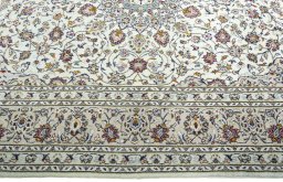 Corner detail of 2000s Kashan rug showing border pattern and Wool pile