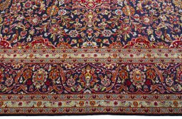 Corner detail of 2000s Kashan rug showing border pattern and Wool pile