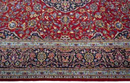Corner detail of New Kashan rug showing border pattern and Cork pile