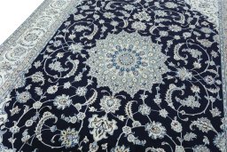 Backside of handmade New Nain rug showing knot structure and weave density
