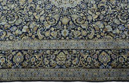 Corner detail of New Kashan rug showing border pattern and Cork pile