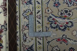 Backside of handmade 2000s Kashan rug showing knot structure and weave density
