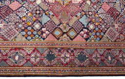 Corner detail of 2000s Kashan rug showing border pattern and Wool pile
