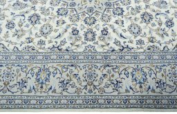 Corner detail of 2000s Kashan rug showing border pattern and Wool pile