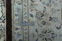 Backside of handmade New Kashan rug showing knot structure and weave density