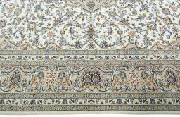 Corner detail of 2000s Kashan rug showing border pattern and Wool pile