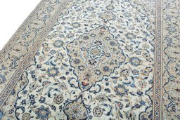 Backside of handmade 2000s Kashan rug showing knot structure and weave density