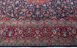 Corner detail of New Kashan rug showing border pattern and Cork pile