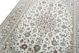 Backside of handmade 2000s Kashan rug showing knot structure and weave density
