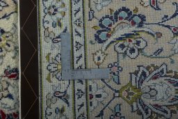 Backside of handmade 2000s Kashan rug showing knot structure and weave density