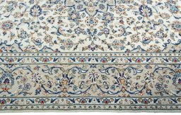 Corner detail of 2000s Kashan rug showing border pattern and Wool pile