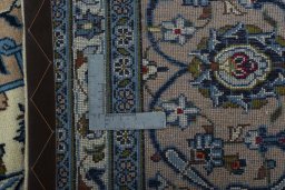 Backside of handmade 2000s Kashan rug showing knot structure and weave density
