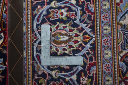 Backside of handmade New Kashan rug showing knot structure and weave density