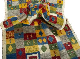 Corner detail of 2000s Persian Gabbeh rug showing border pattern and Wool pile