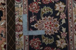 Backside of handmade 2000s Tabriz 50/60/70 Raj rug showing knot structure and weave density