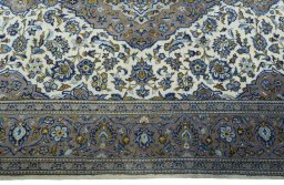 Corner detail of 2000s Kashan rug showing border pattern and Wool pile