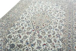 Backside of handmade 2000s Kashan rug showing knot structure and weave density