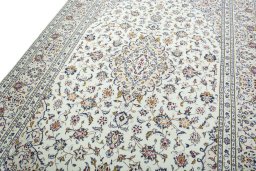 Backside of handmade 2000s Kashan rug showing knot structure and weave density