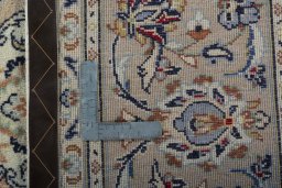 Backside of handmade New Kashan rug showing knot structure and weave density