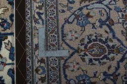 Backside of handmade 2000s Kashan rug showing knot structure and weave density