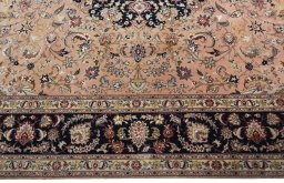Corner detail of 2000s Tabriz 50/60/70 Raj rug showing border pattern and Cork pile